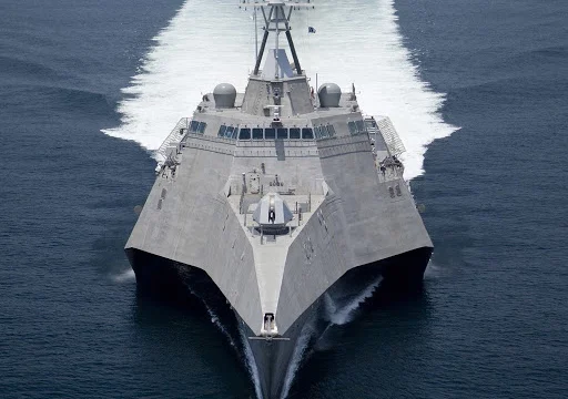 navy ship running over the sea