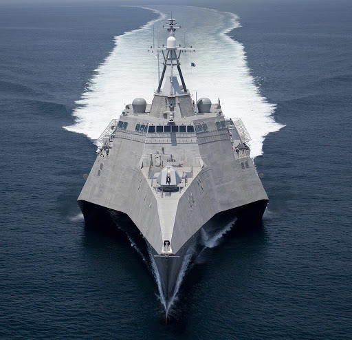 navy ship running over the sea