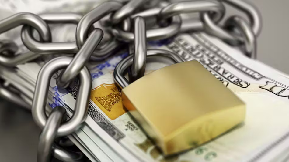 Stack of U.S. hundred-dollar bills wrapped in a thick chain and secured with a gold padlock.